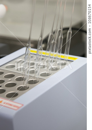 Closeup of lab equipment for scientific research with fluids Closeup of lab equipment for scientific research with fluids 108670154