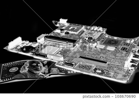 The old microcircuit from the laptop rests on a bank note in a negative color 108670690