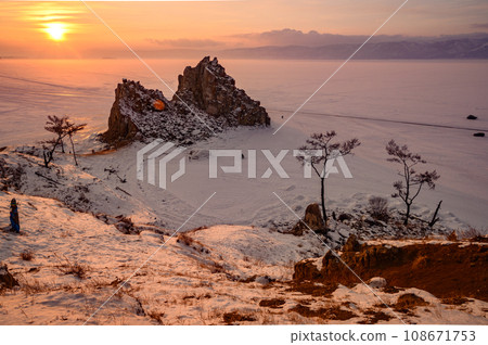 Sunset view of Shaman rock one of sacred place in frozen lake Baikal in winter season of Siberia, Russia. 108671753