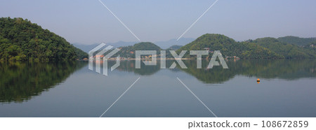 Green hills reflecting in Lake Begnas, Nepal. Green hills reflecting in Lake Begnas, Nepal. 108672859