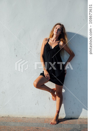 beautiful woman standing near a white wall walking rest 108673631