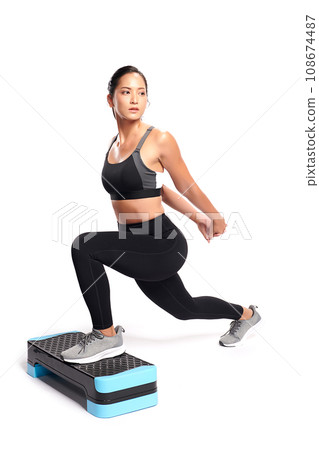 an asian woman is  working out  wearing the sport exercise suit with white background. 108674487