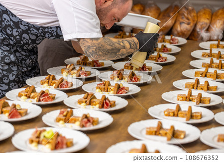 Chef decorating many starter plate Chef decorating many starter plate 108676352