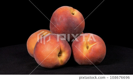 Close-up footage of peach fruit on black background. Close-up footage of peach fruit on black background. 108676696