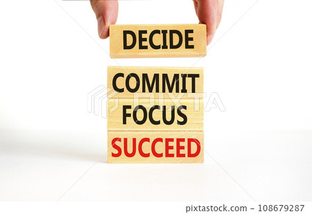 Decide commit focus succeed symbol. Concept word Decide Commit Focus Succeed on wooden block. Beautiful white background. Businessman hand. Business decide commit focus succeed concept. Copy space. 108679287