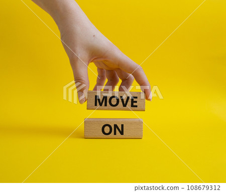 Move on symbol. Wooden blocks with words Move on. Beautiful yellow background. Businessman hand. Business and Move on concept. Copy space. 108679312