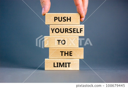 Push the limit symbol. Concept words Push yourself to the limit on wooden blocks. Beautiful grey table grey background. Businessman hand. Business push the limit concept. Copy space. Push the limit symbol. Concept words Push yourself to the limit on wooden blocks. Beautiful grey table grey background. Businessman hand. Business push the limit concept. Copy space. 108679445