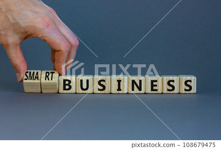 Time to smart business symbol. Wooden cubes with words 'Smart business'. Businessman hand. Beautiful grey background. Smart success business concept. Copy space. 108679475