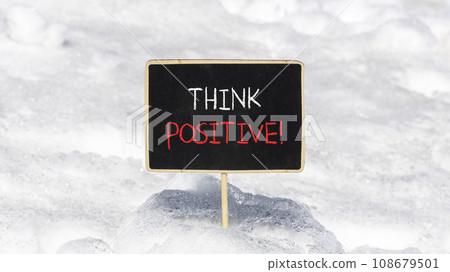Think positive symbol. Concept words Think positive on beautiful chalk blackboard. Beautiful white snow background. White snow. Business, motivational think positive thinking concept. Copy space. 108679501