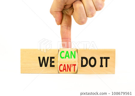 We can do it symbol. Concept word We can or can not do it on beautiful wooden cubes. Beautiful white table white background. Businessman hand. Business and we can or not do it concept. Copy space. 108679561
