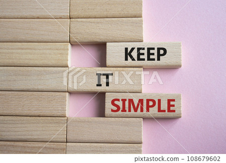 Keep it Simple symbol. Concept words Keep it Simple on wooden blocks. Beautiful pink background. Business and Keep it Simple concept. Copy space. 108679602