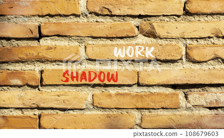 Shadow work psychology symbol. Concept words Shadow work on beautiful brown brick wall. Beautiful brown brick wall background. Psychology shadow work concept. Copy space. 108679603