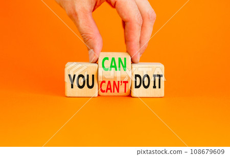 You can do it symbol. Concept word You can or can not do it on beautiful wooden cubes. Beautiful orange table orange background. Businessman hand. Business and you can or not do it concept. Copy space 108679609