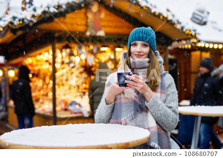 woman drinking hot punch on German Christmas market. 108680707