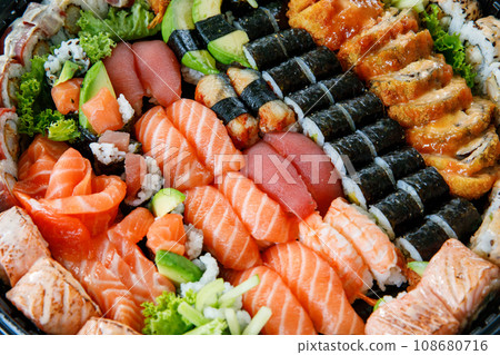 Assorted Sushi Nigiri and Maki Big Set on Slate. A Variety of Japanese Sushi with Tuna, Crab, Salmon, Eel, and Rolls. Top View. 108680716