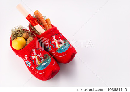 Dutch children shoes filled with treatsr for St Nicholas Day Dutch children shoes filled with treatsr for St Nicholas Day 108681143