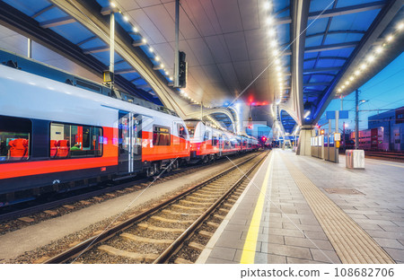 High speed train on the modern railway station at night 108682706