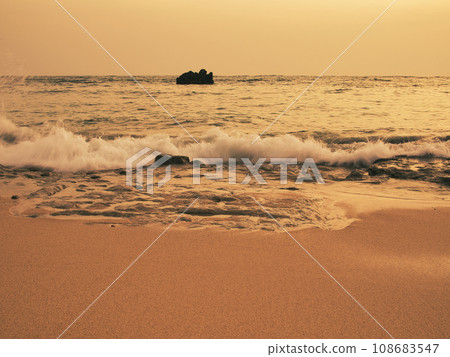 Waves illuminated by the setting sun. Yomitan Village, Okinawa Prefecture. 108683547