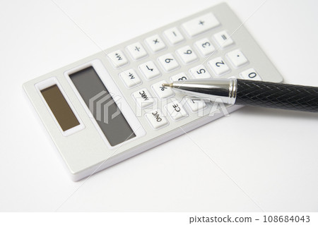 Close-up of calculator and pen, white background Close-up of calculator and pen, white background 108684043