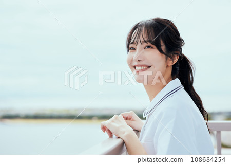 Nurse looking up at the sky on the rooftop 108684254