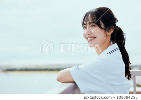 Nurse looking up at the sky on the rooftop Nurse looking up at the sky on the rooftop 108684255