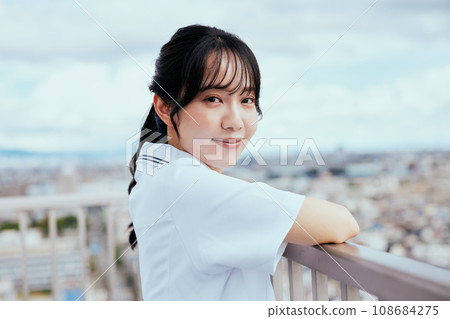 Nurse looking up at the sky on the rooftop Nurse looking up at the sky on the rooftop 108684275