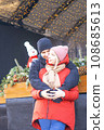 Happy girl and boy hugging in front of Christmas decoration in winter. 108685613