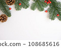 Christmas background. Green branches with red berries and brown cones. 108685616
