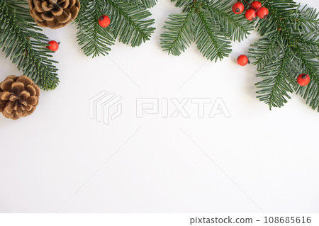 Christmas background. Green branches with red berries and brown cones. Christmas background. Green branches with red berries and brown cones. 108685616
