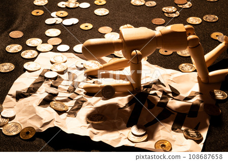 A doll with drooping heads suffering from the tax increase amid scattered coins 108687658