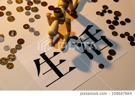 A doll with drooping heads struggling to survive among scattered coins 108687664