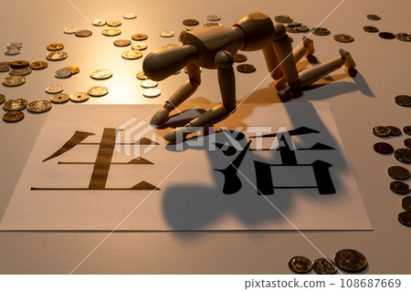 A doll with drooping heads struggling to survive among scattered coins 108687669