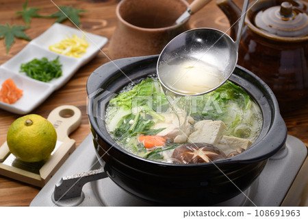 Winter Taste: Chicken Mizutaki Scooping out the soup stock from hot pot dishes Winter Taste: Chicken Mizutaki Scooping out the soup stock from hot pot dishes 108691963