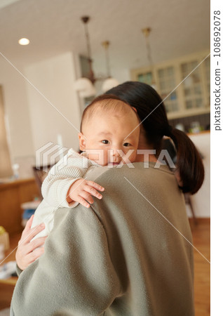 Baby held by mother, Burp, vertically held Baby held by mother, Burp, vertically held 108692078