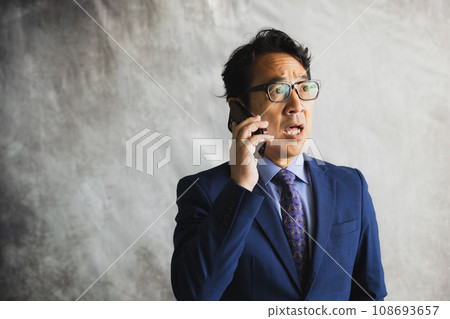 A middle-aged businessman wearing a suit A middle-aged businessman wearing a suit 108693657