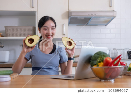 Young Asian healthy beautiful woman with casual clothes is smile and slicing fresh fruit to diet at home in kitchen in holiday Young Asian healthy beautiful woman with casual clothes is smile and slicing fresh fruit to diet at home in kitchen in holiday 108694037