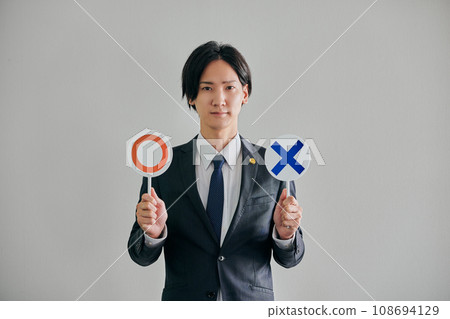 A male lawyer deciding whether it is legal or illegal against a white background A male lawyer deciding whether it is legal or illegal against a white background 108694129