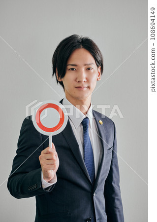 A male lawyer makes a judgment against a white background 108694149