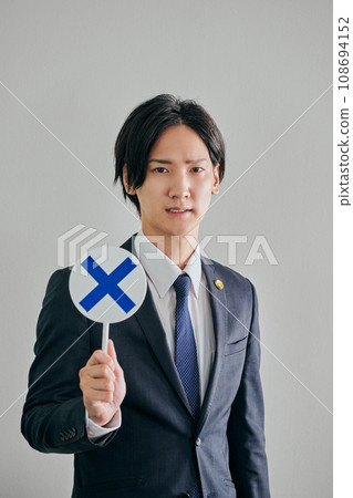 A male lawyer making a judgment against a white background 108694152