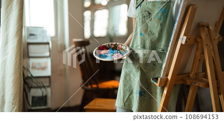 hand of artist with brush painting picture art, creativity, artistic and artwork, painting, Colorful artist brushes and paint palette concept 108694153