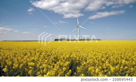 Wind turbine in a yellow flower field, Alternative energy. Generative AI 108695443