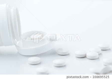 Pharmacy concept. White pills out of pill botle. 108695525
