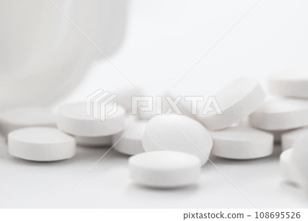 Opioid pain medication, narcotic, close up white pills with a bottle. 108695526