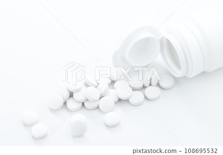 Drug abuse and overdose concept with scattered prescription opioids spilling from bottle with copy space. Drug abuse and overdose concept with scattered prescription opioids spilling from bottle with copy space. 108695532