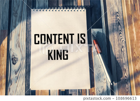 Notepad with the inscription CONTENT IS KING on a vintage table with a beautiful effect Notepad with the inscription CONTENT IS KING on a vintage table with a beautiful effect 108696613