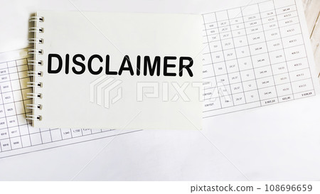 Notepad with disclaimer text lying on documents and white background 108696659