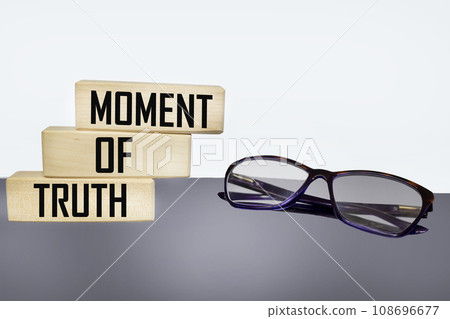 Moment of truth text on wooden blocks and light background with glasses 108696677