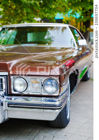 Headlight of a brown retro car.  108697704