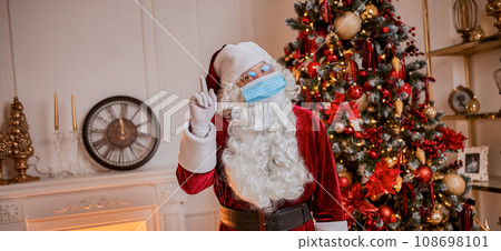 Santa Claus wearing protective mask . Merry Christmas Covid 19 coronavirus social distance concept. Santa Claus wearing protective mask . Merry Christmas Covid 19 coronavirus social distance concept. 108698101
