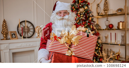 Happy Santa Claus brought gifts to children. New year and Merry Christmas holidays concept Happy Santa Claus brought gifts to children. New year and Merry Christmas holidays concept 108698124